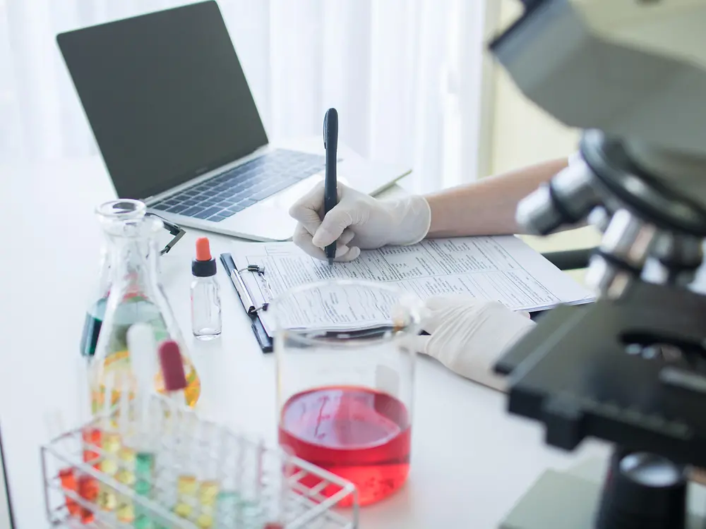 Different beakers and test tubes, also a microscope represent the efforts in analysis of whole products or just ingredients.